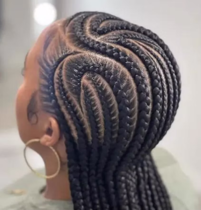 Curved feed-in cornrows styled to the side in Austin, Texas
